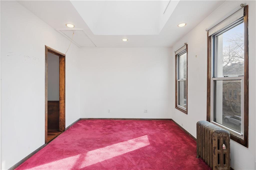 457 44th Street Brooklyn, NY 11220 - Photo 8 of 16 a bedroom with a bed and a window