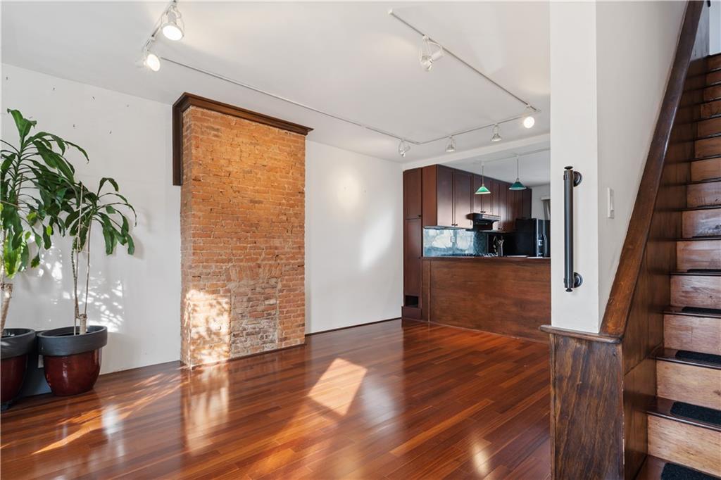 457 44th Street Brooklyn, NY 11220 - Photo 10 of 16 a view of empty room with wooden floor and fan
