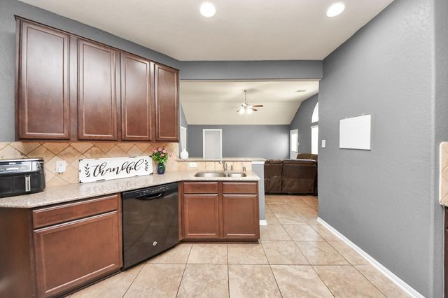 a kitchen with stainless steel appliances granite countertop a sink and cabinets