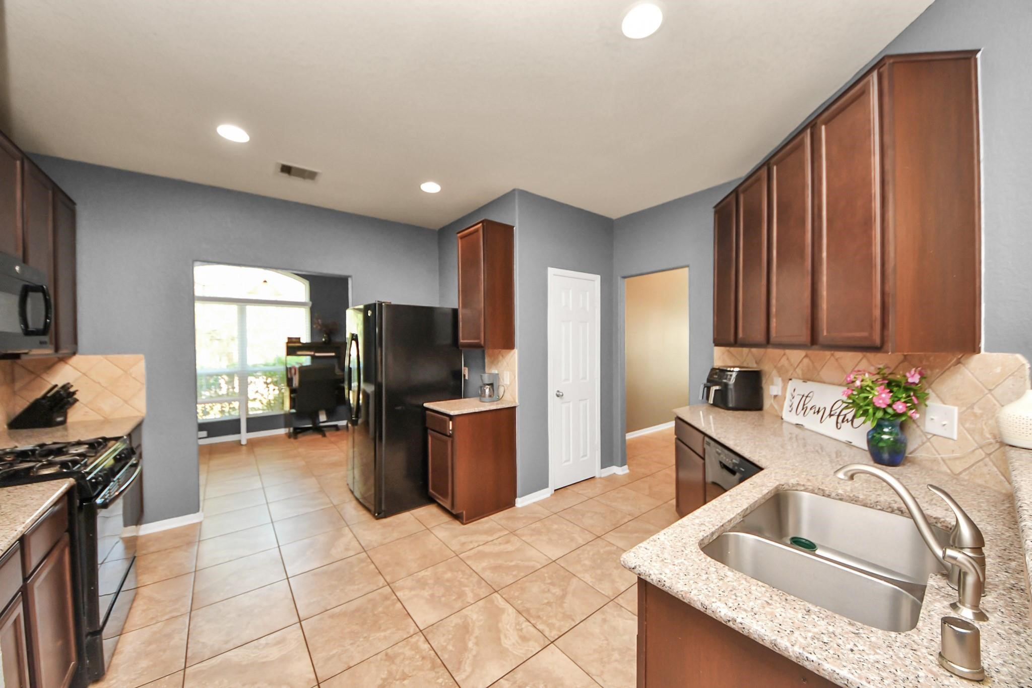 15003 Signal Ridge Way Cypress, TX 77429 - Photo 13 of 40 a kitchen with sink refrigerator and stove