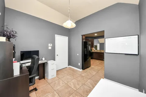 a view of a hallway with a livingroom and furniture