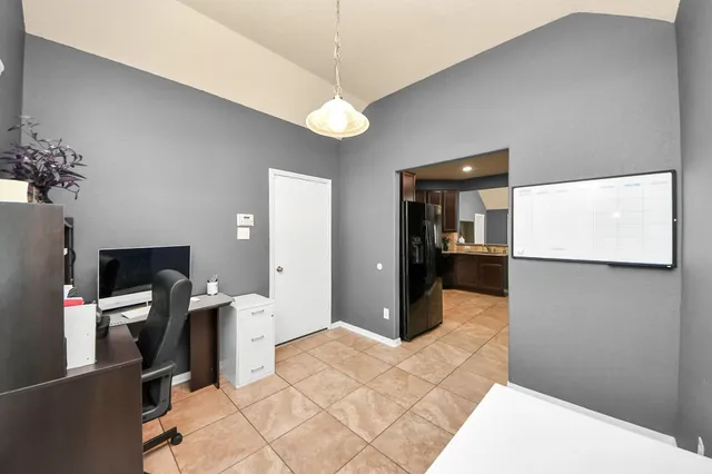 a view of a hallway with a livingroom and furniture