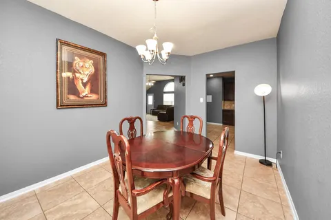a dining room with furniture and chandelier