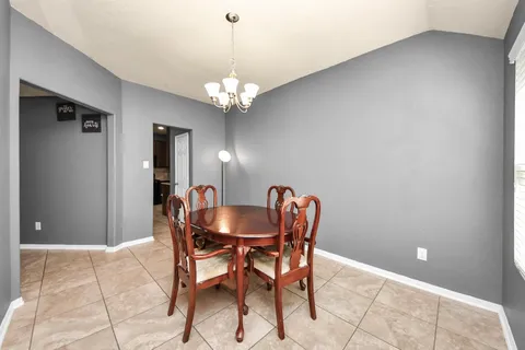 a dining room with furniture and chandelier
