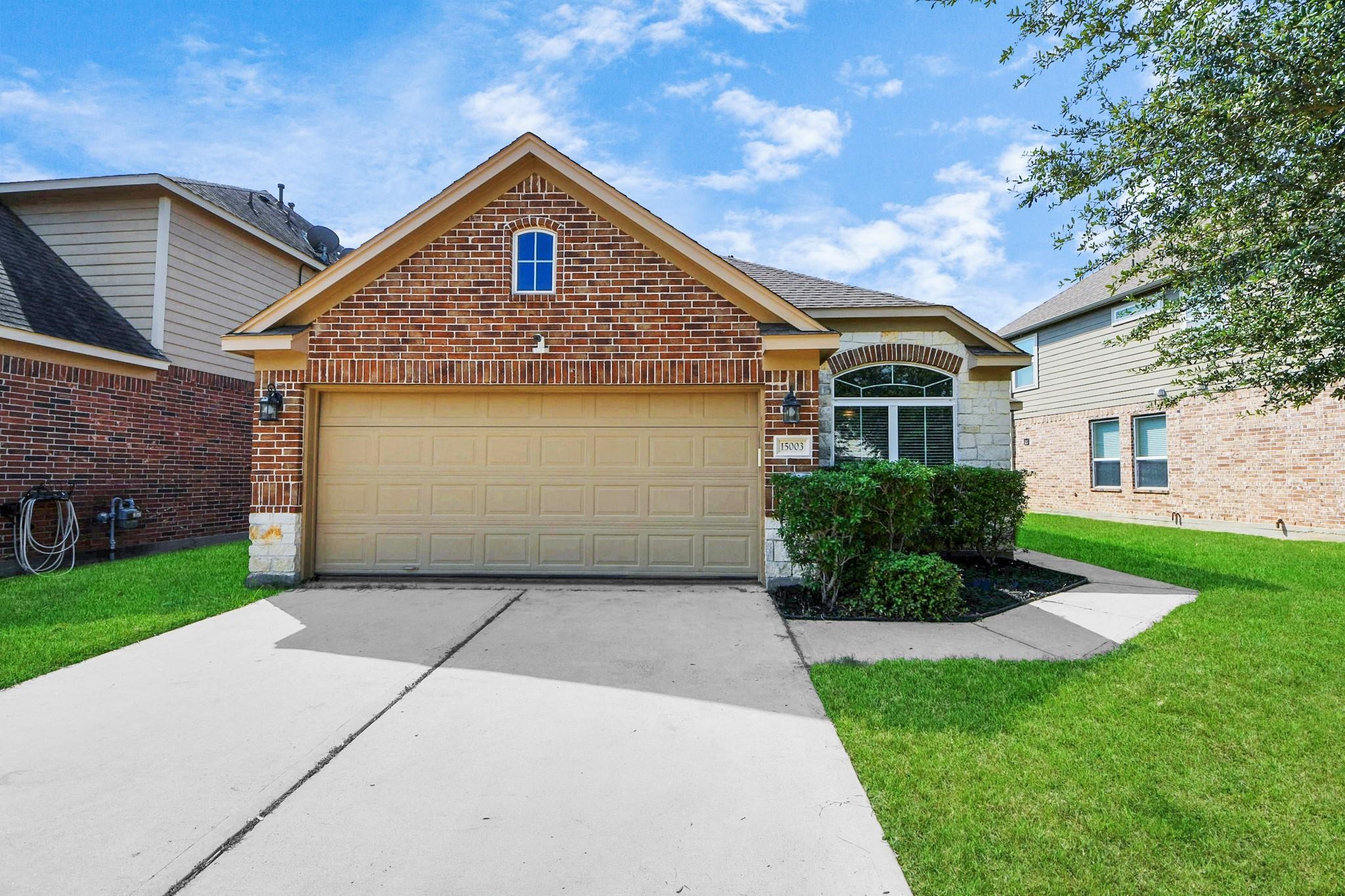 15003 Signal Ridge Way Cypress, TX 77429 - Photo 2 of 40 a front view of a house with a yard and garage