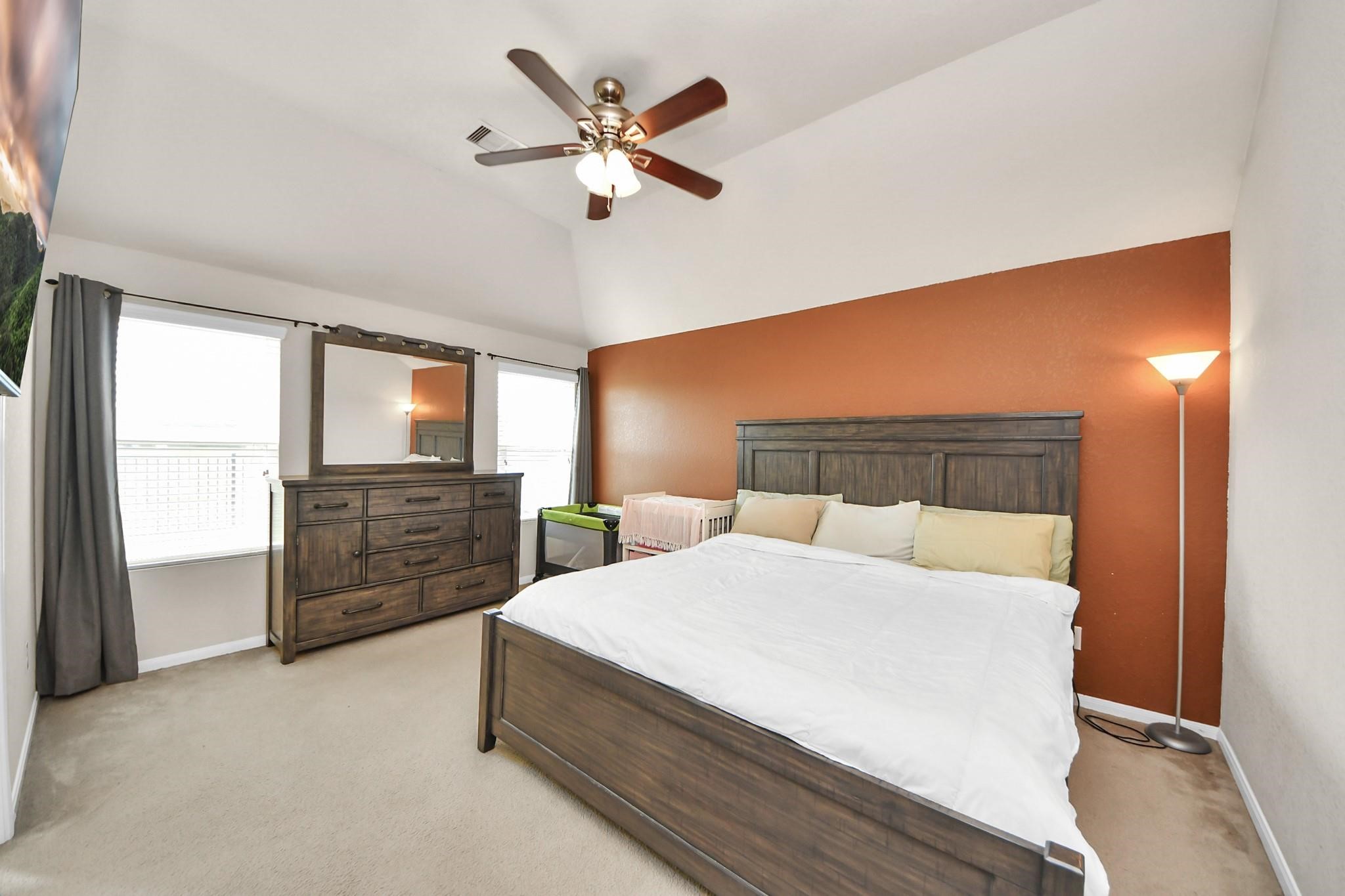 15003 Signal Ridge Way Cypress, TX 77429 - Photo 22 of 40 a bedroom with a bed and a chandelier