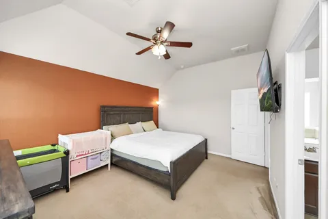 a bedroom with a bed and a chandelier