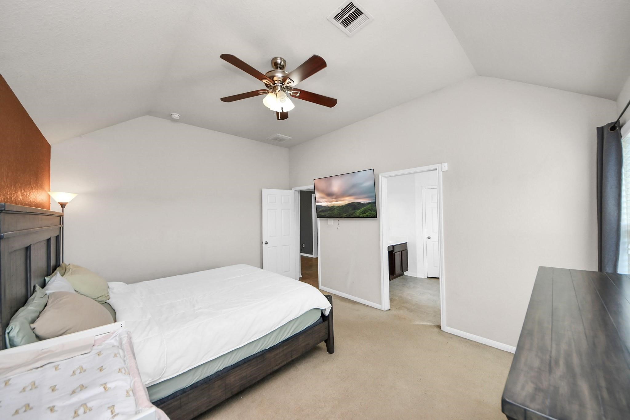 15003 Signal Ridge Way Cypress, TX 77429 - Photo 24 of 40 a bedroom with a bed and a chandelier