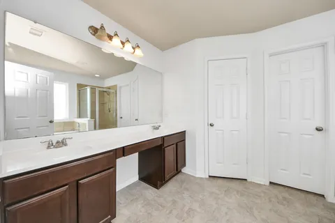 a bathroom with a double vanity sink and mirror