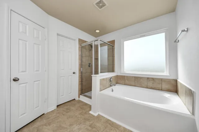 a bathroom with a bathtub and a shower