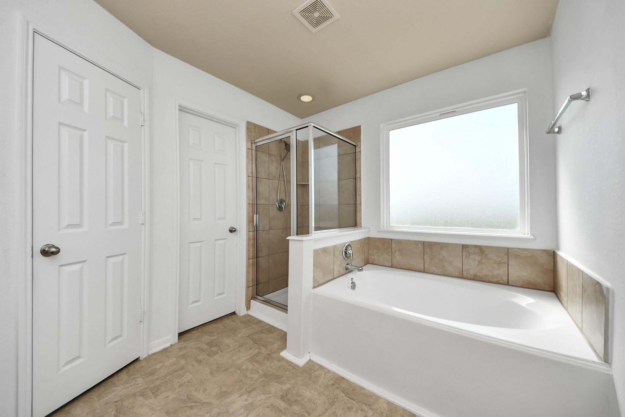 15003 Signal Ridge Way Cypress, TX 77429 - Photo 27 of 40 a bathroom with a bathtub and a shower
