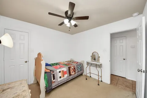 a bedroom with bed and a chandelier