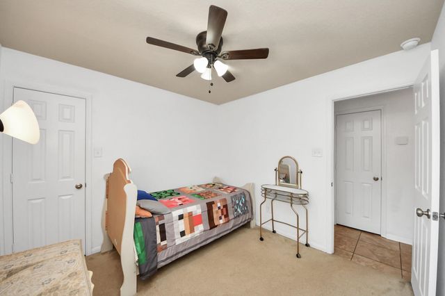 a bedroom with bed and a chandelier