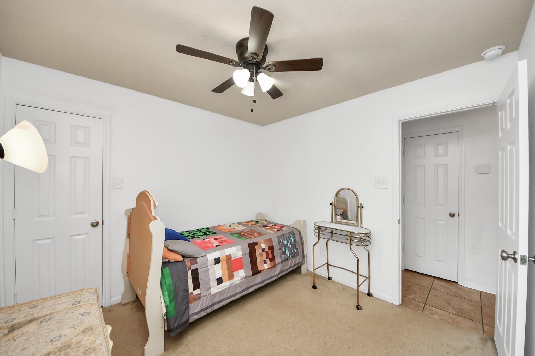 15003 Signal Ridge Way Cypress, TX 77429 - Photo 29 of 40 a bedroom with bed and a chandelier