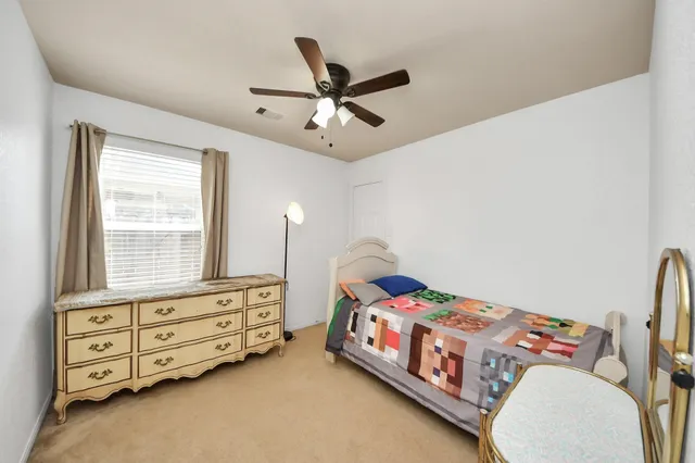 a bedroom with a bed and a tv