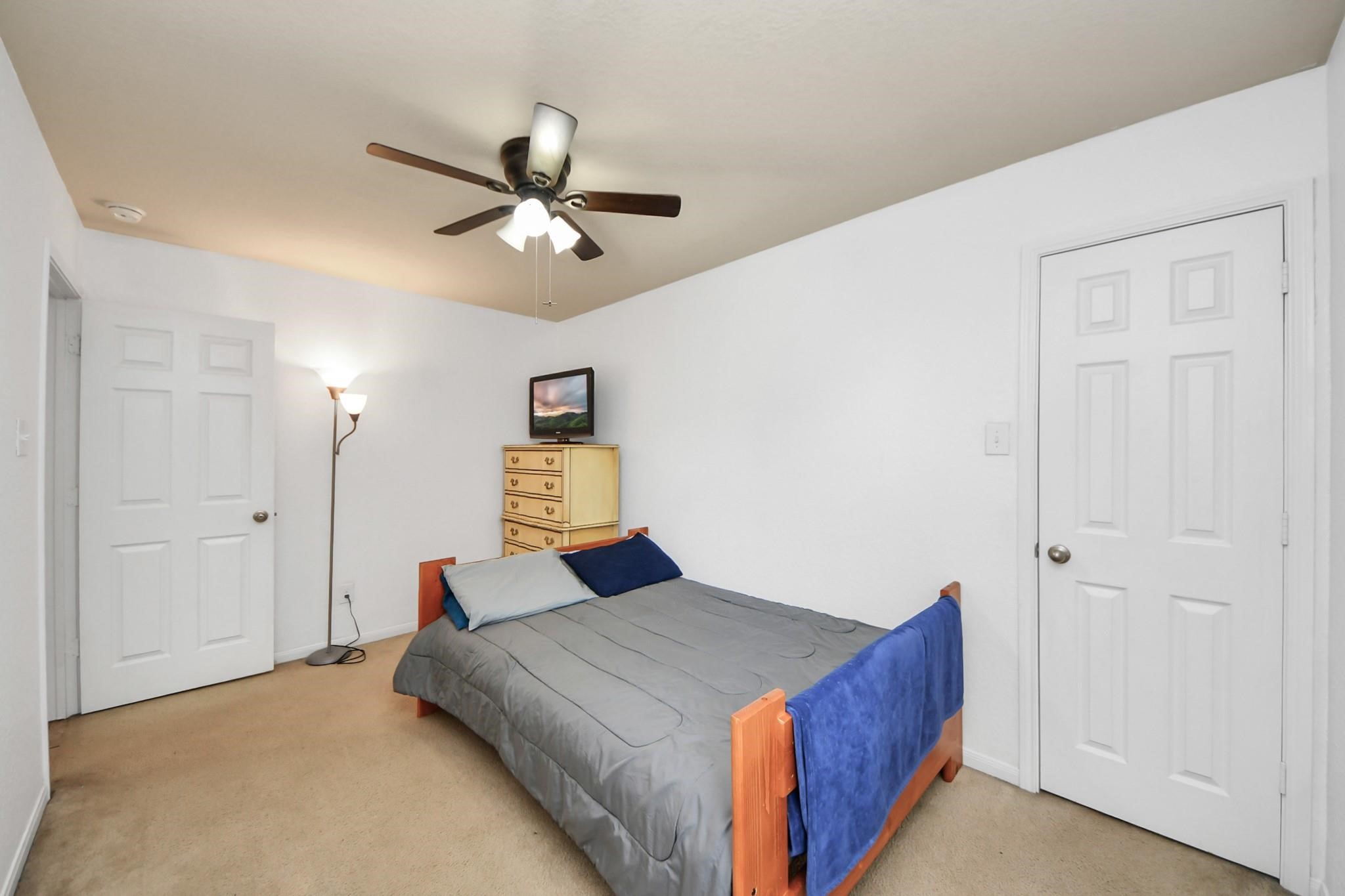 15003 Signal Ridge Way Cypress, TX 77429 - Photo 33 of 40 a bedroom with a bed and a chandelier