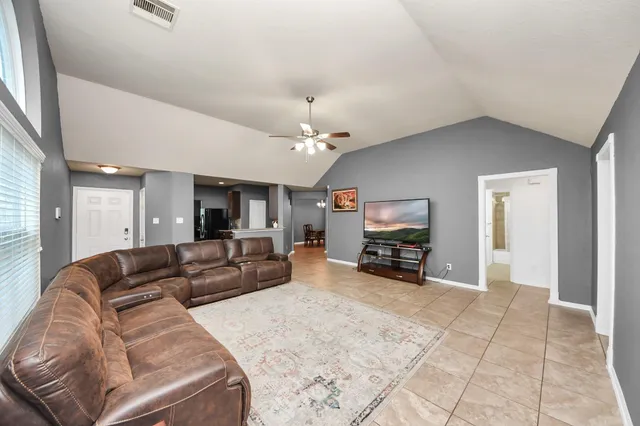 a living room with furniture and a flat screen tv