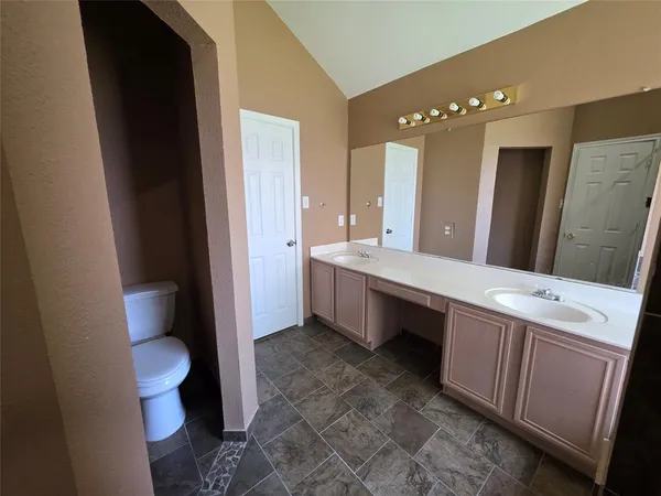 a bathroom with a double vanity sink and a mirror