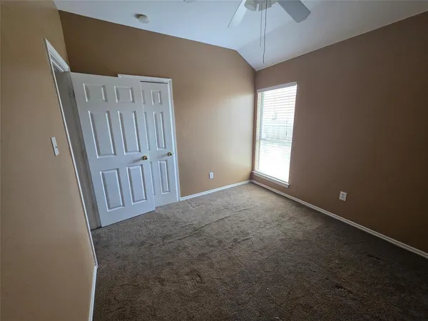 an empty room with windows and entrance