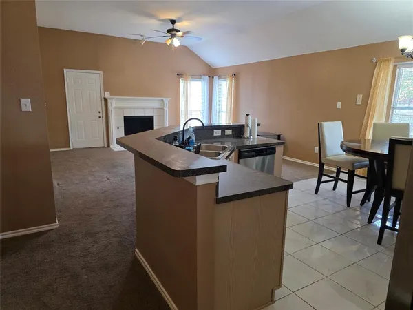 a living room with furniture a fireplace and a chandelier
