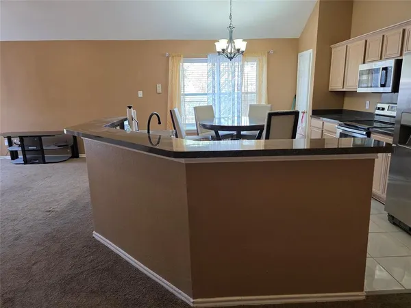a kitchen with stainless steel appliances a sink and a stove