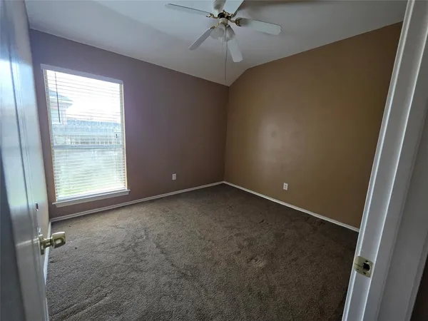 a bathroom with a toilet mirror and vanity