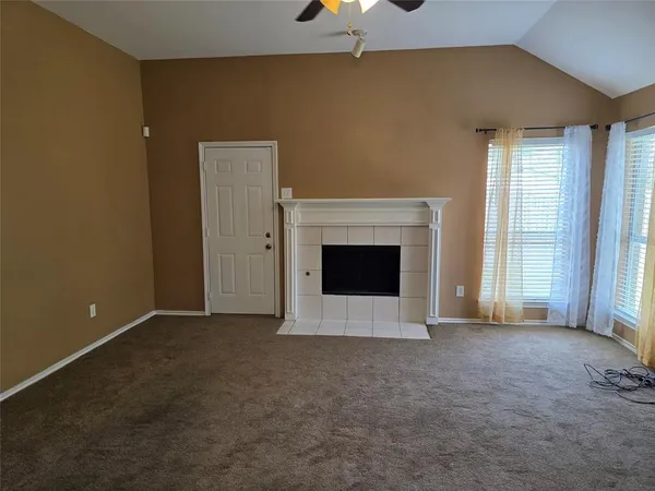 a kitchen with stainless steel appliances granite countertop a table chairs and a refrigerator