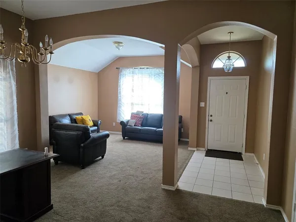 a living room with furniture and a mirror