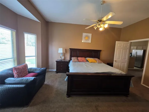 a bedroom with a bed couch and window