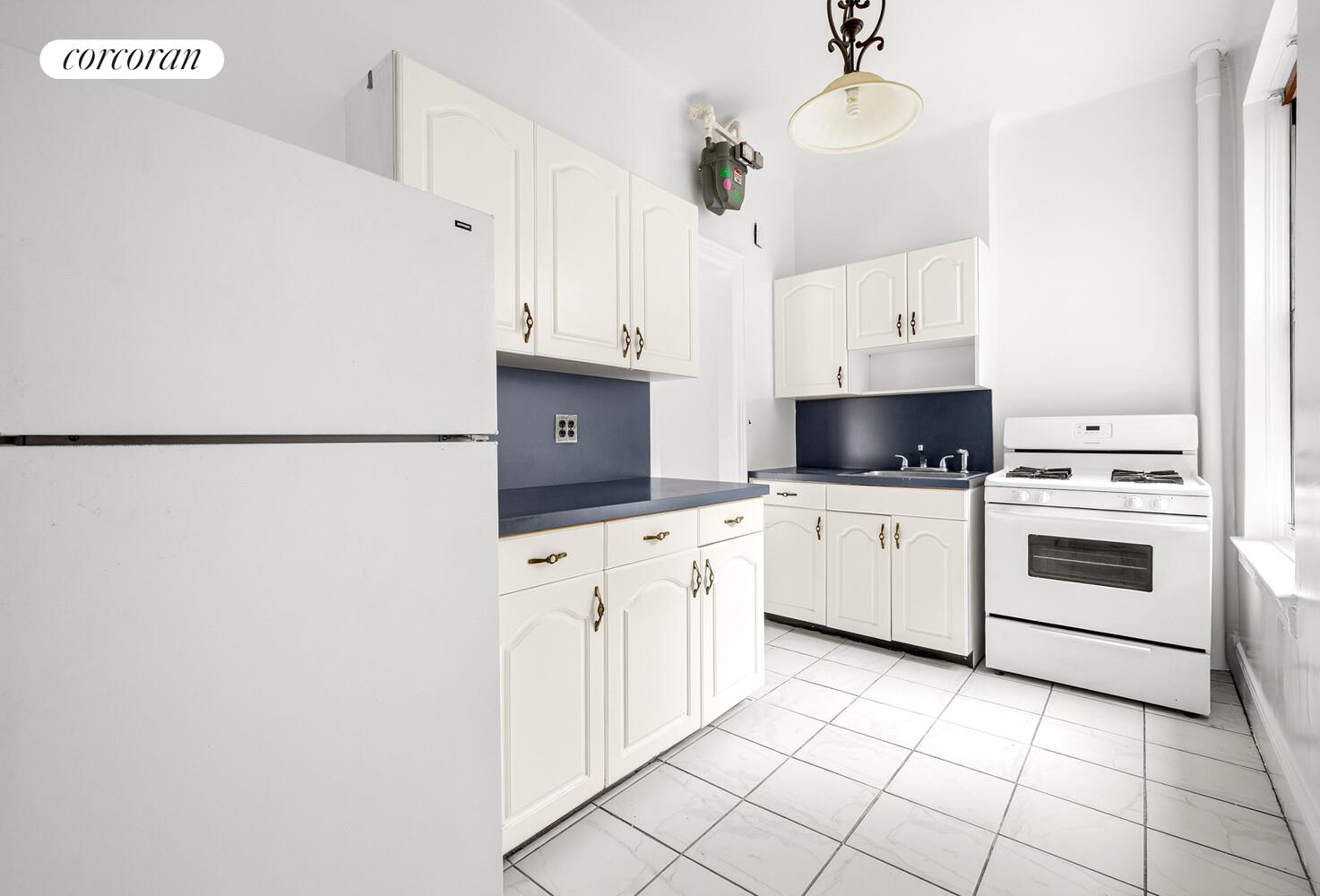 318 West 100th Street, Unit 7D Manhattan, NY 10025 - Photo 13 of 17 a kitchen with cabinets and white appliances