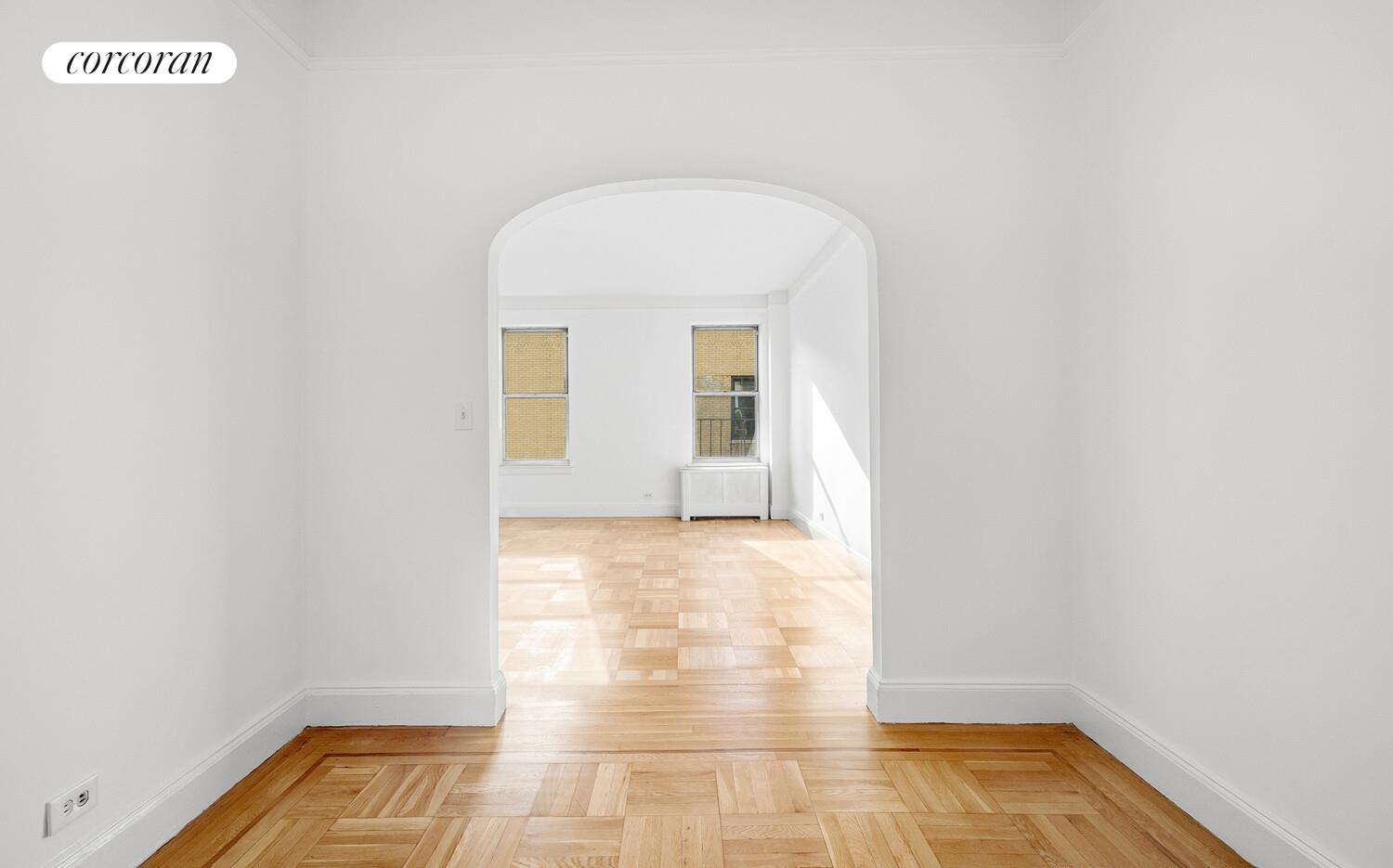 318 West 100th Street, Unit 7D Manhattan, NY 10025 - Photo 5 of 17 a view of an empty room with wooden floor and a window
