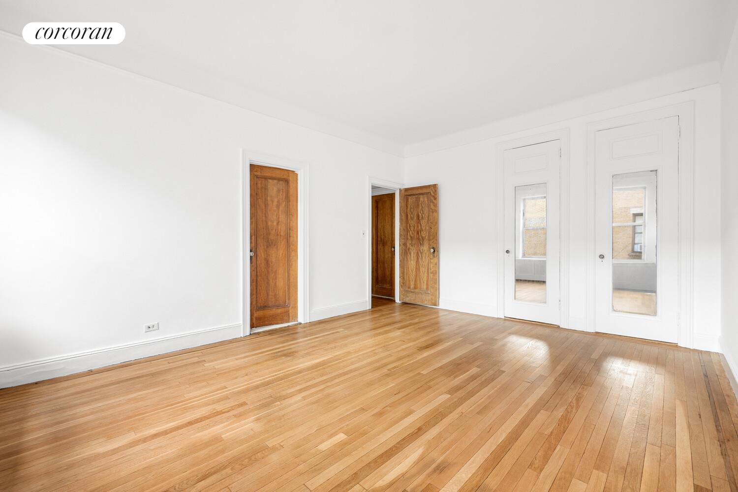 318 West 100th Street, Unit 7D Manhattan, NY 10025 - Photo 9 of 17 a view of an empty room with wooden floor