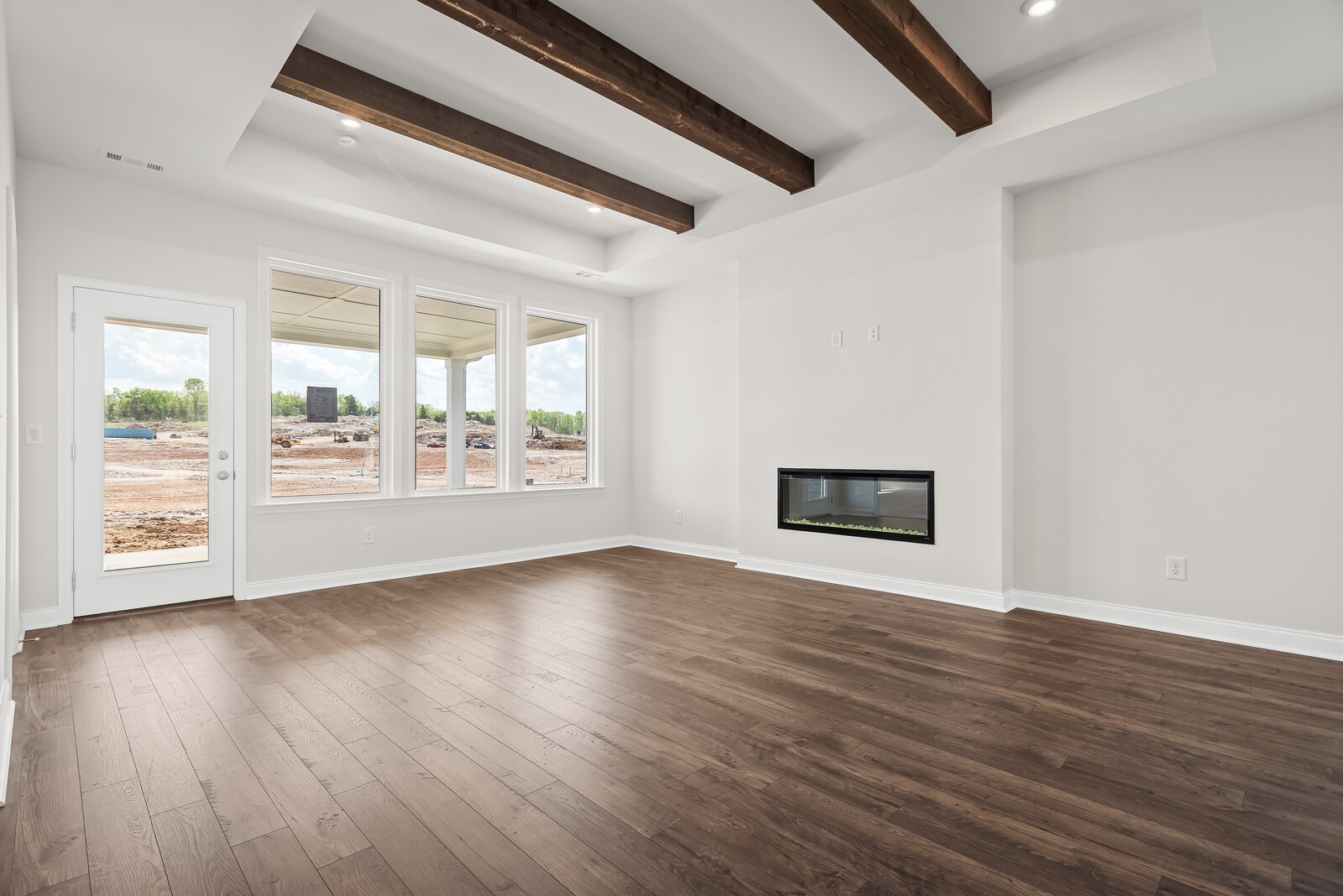 7108 Comstock Road Spring Hill, TN 37174 - Photo 21 of 70 a view of an empty room with wooden floor and a window