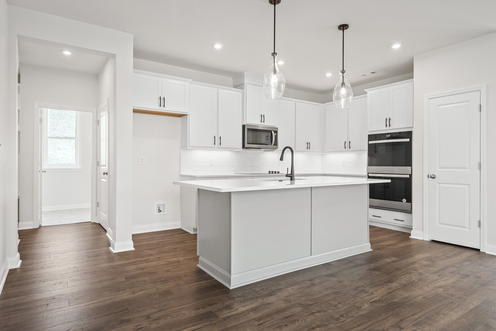 7108 Comstock Road Spring Hill, TN 37174 - Photo 27 of 70 a kitchen with kitchen island a white counter top space cabinets and stainless steel appliances