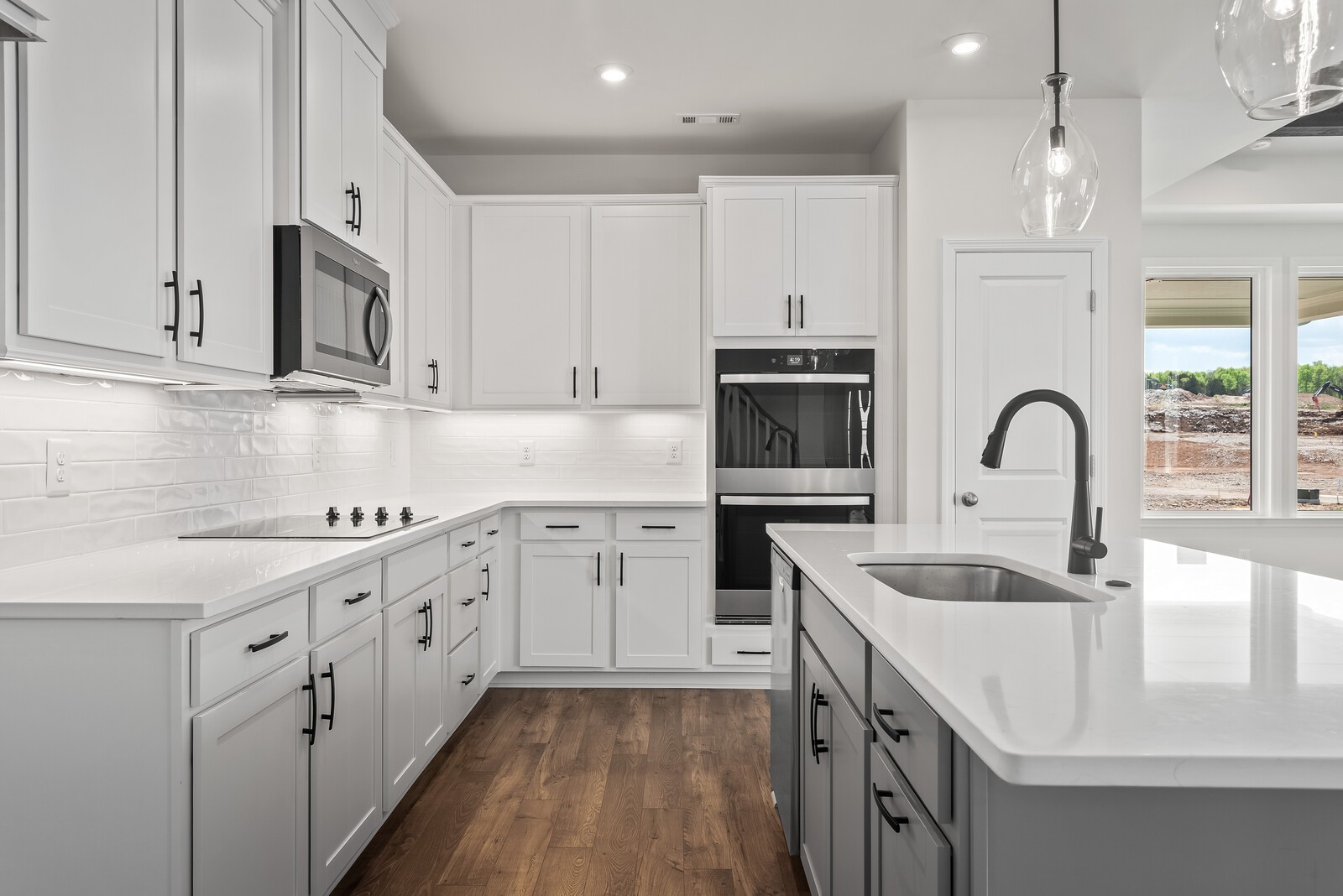 7108 Comstock Road Spring Hill, TN 37174 - Photo 29 of 70 a kitchen with granite countertop white cabinets and stainless steel appliances