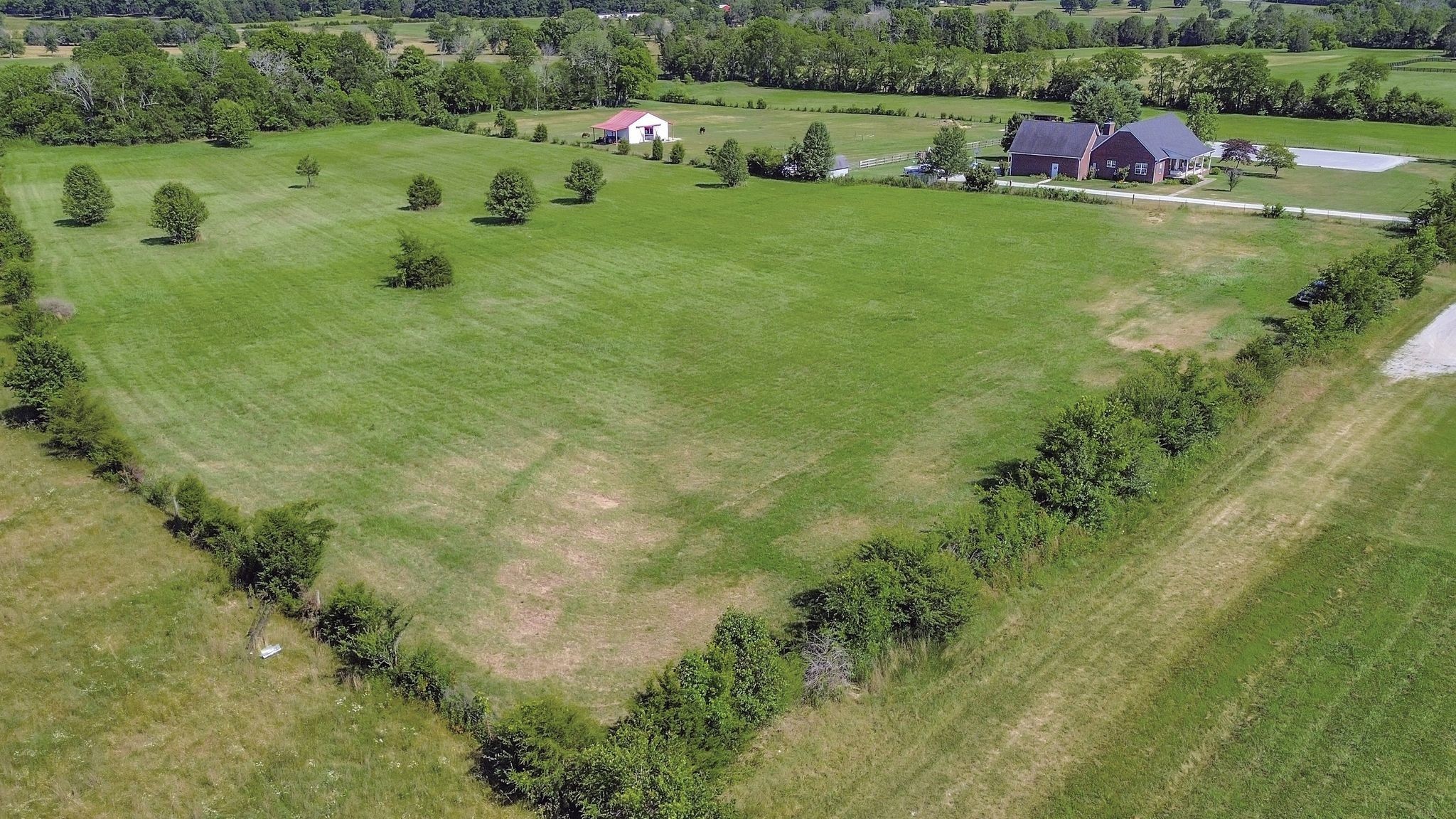 7108 Comstock Road Spring Hill, TN 37174 - Photo 5 of 70 a view of a lake with a yard and large trees
