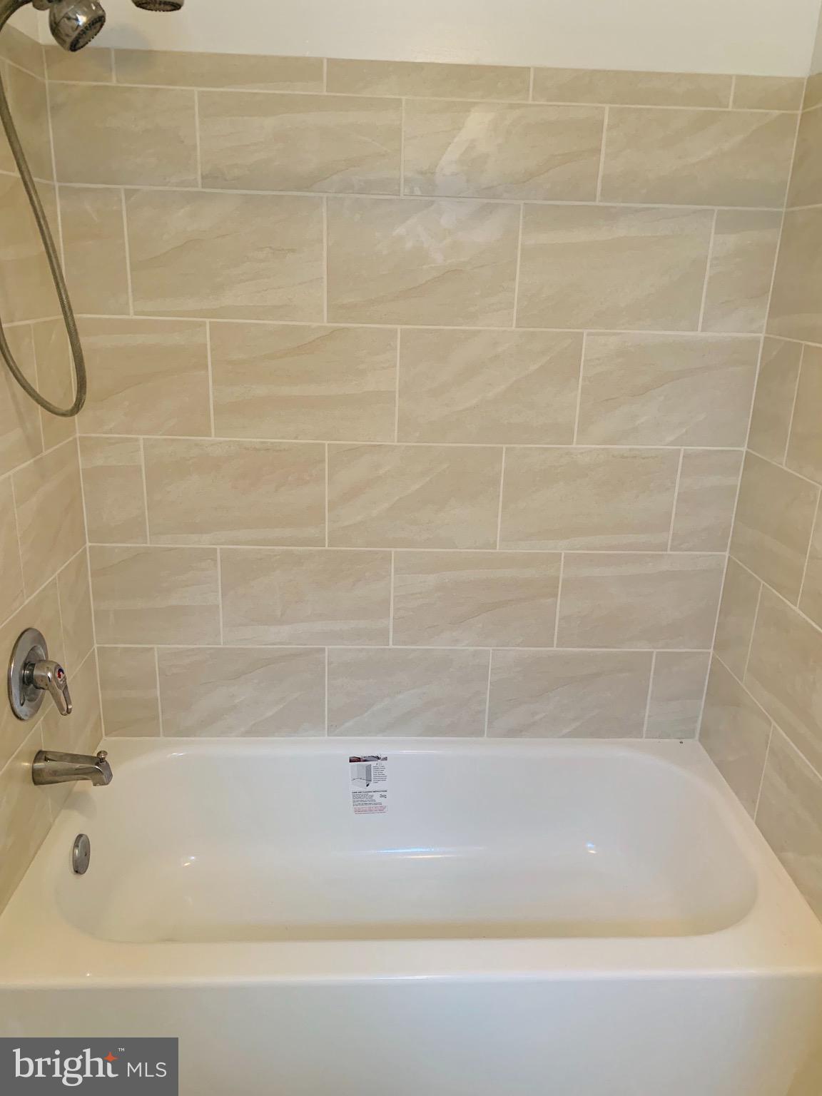 5902 Flanders Street Springfield, VA 22150 - Photo 34 of 45 Beautiful ceramic tile surround the bath tub.