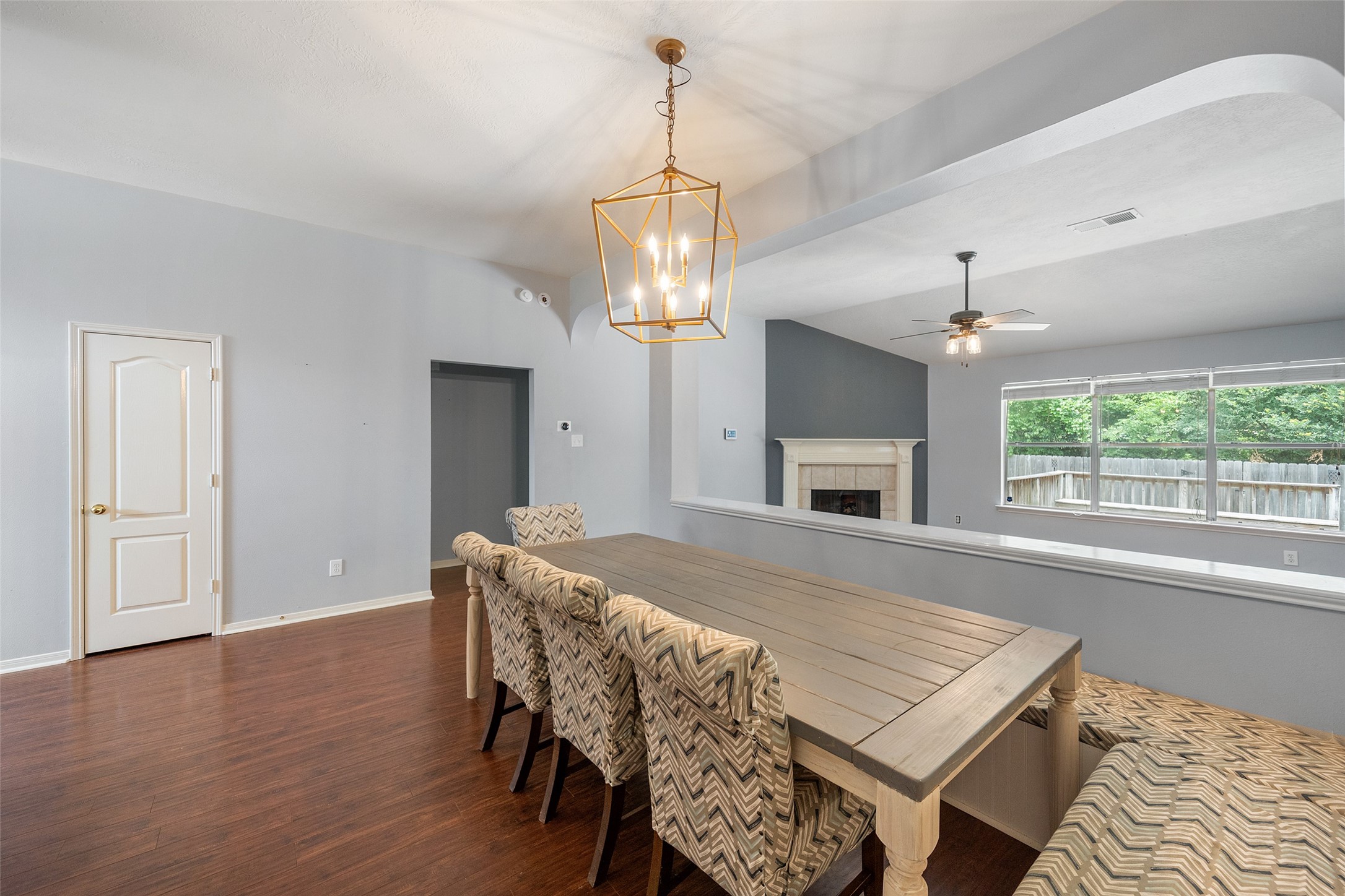 19718 Teller Boulevard Spring, TX 77388 - Photo 7 of 47 a dining room with wooden floor a chandelier a wooden table and chairs