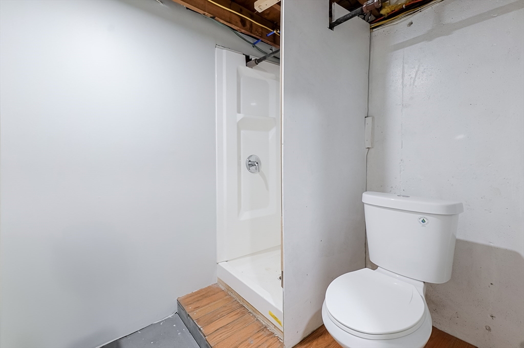 5 Oliver Street Randolph, MA 02368 - Photo 23 of 29 a white toilet sitting next to a bathroom sink