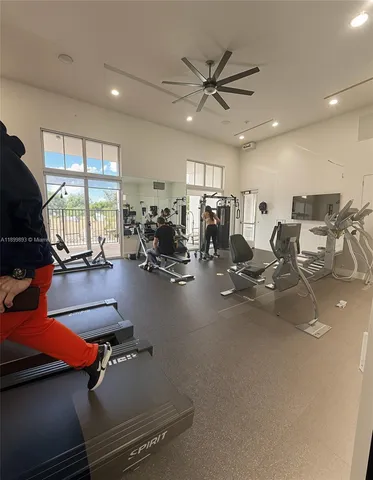 a room with gym equipment and windows