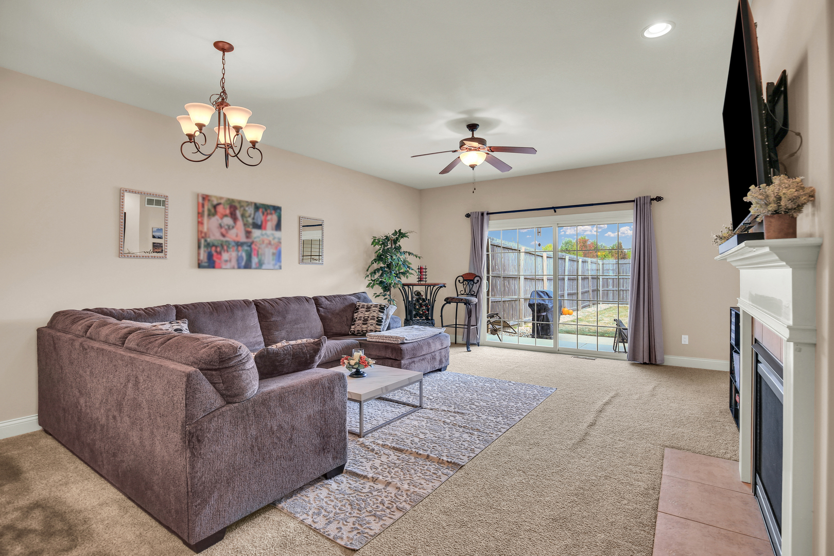 1504 Stonebluff Court, Unit 1504 Champaign, IL 61822 - Photo 11 of 40 a living room with furniture a fireplace and a flat screen tv