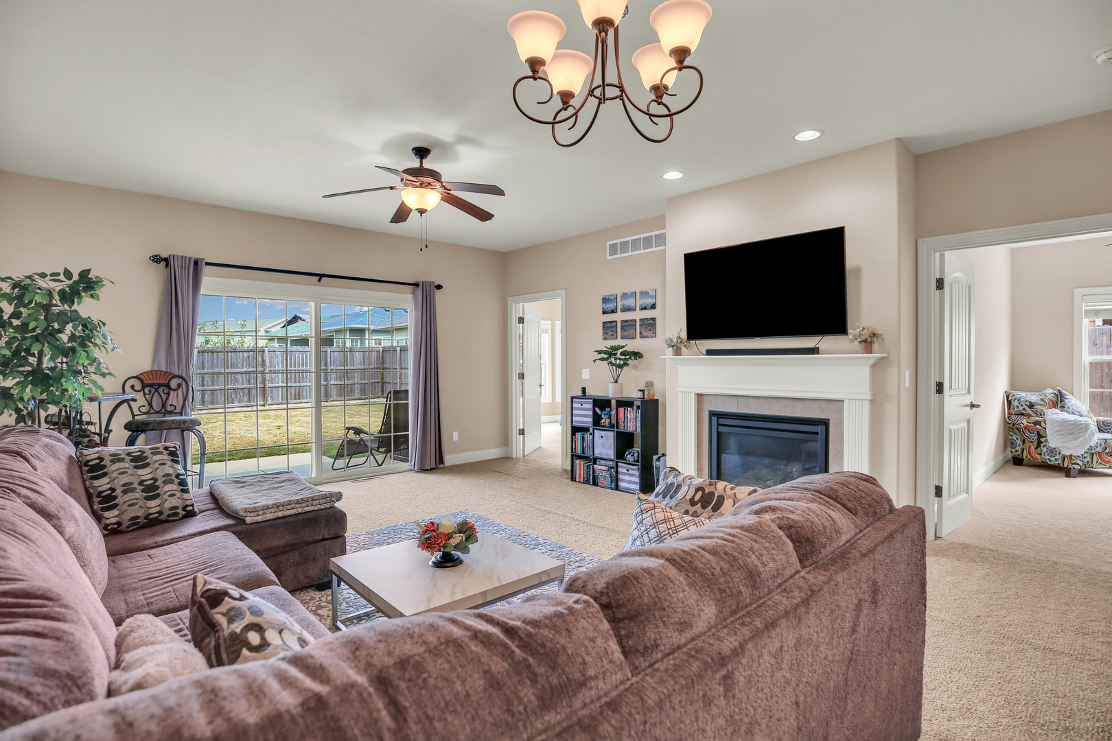 1504 Stonebluff Court, Unit 1504 Champaign, IL 61822 - Photo 12 of 40 a living room with furniture a fireplace and a flat screen tv