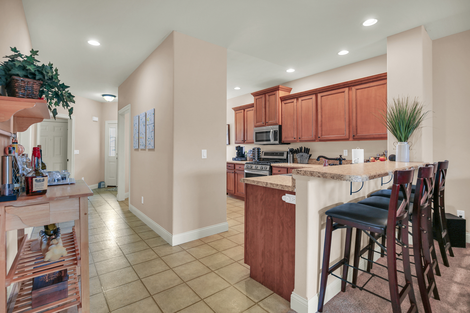 1504 Stonebluff Court, Unit 1504 Champaign, IL 61822 - Photo 15 of 40 a kitchen with kitchen island granite countertop wooden cabinets and counter space