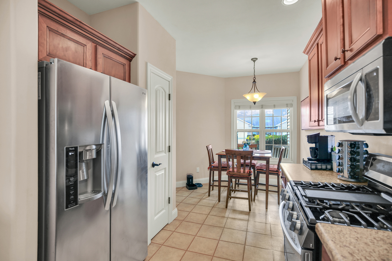 1504 Stonebluff Court, Unit 1504 Champaign, IL 61822 - Photo 16 of 40 a kitchen with stainless steel appliances granite countertop a refrigerator and a stove