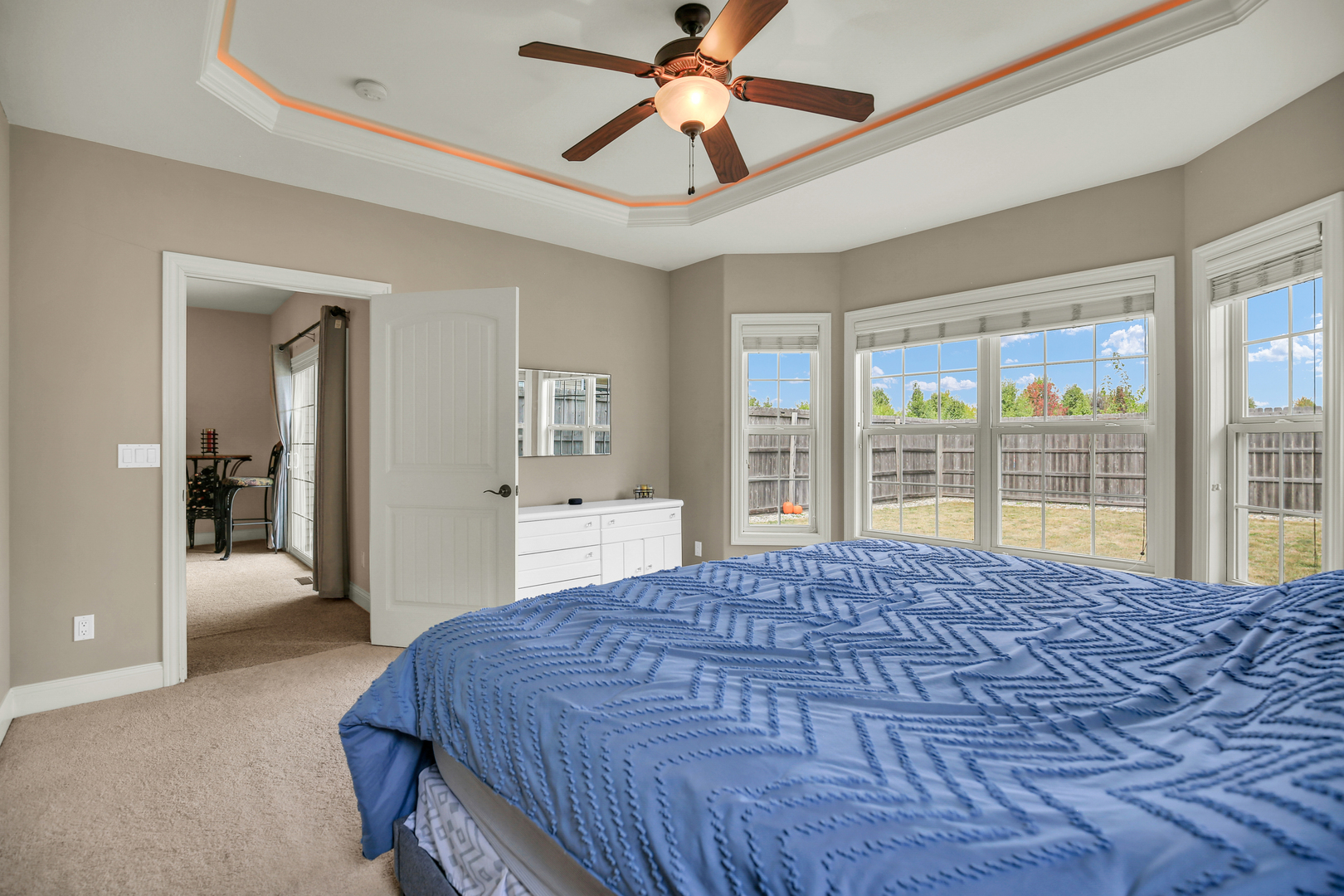1504 Stonebluff Court, Unit 1504 Champaign, IL 61822 - Photo 23 of 40 a bedroom with a large bed and a chandelier fan