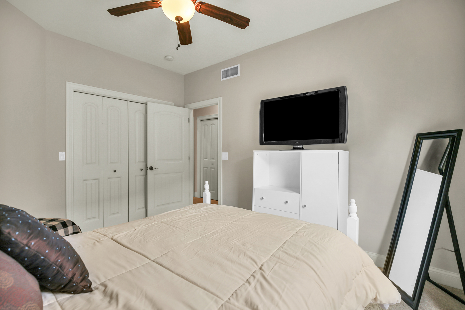 1504 Stonebluff Court, Unit 1504 Champaign, IL 61822 - Photo 28 of 40 a bedroom with a bed and a flat screen tv