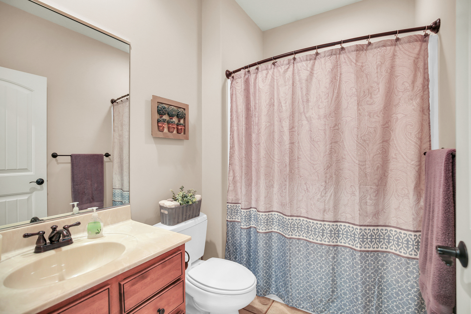 1504 Stonebluff Court, Unit 1504 Champaign, IL 61822 - Photo 29 of 40 a bathroom with a sink a toilet a mirror and shower curtain
