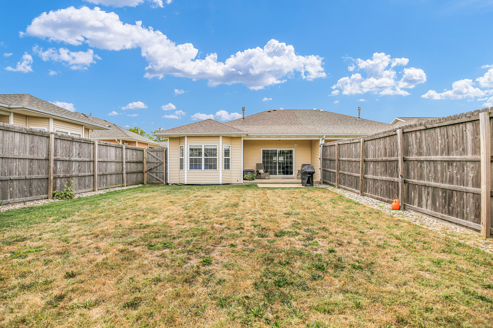 1504 Stonebluff Court, Unit 1504 Champaign, IL 61822 - Photo 31 of 40 a view of a house with a wooden fence