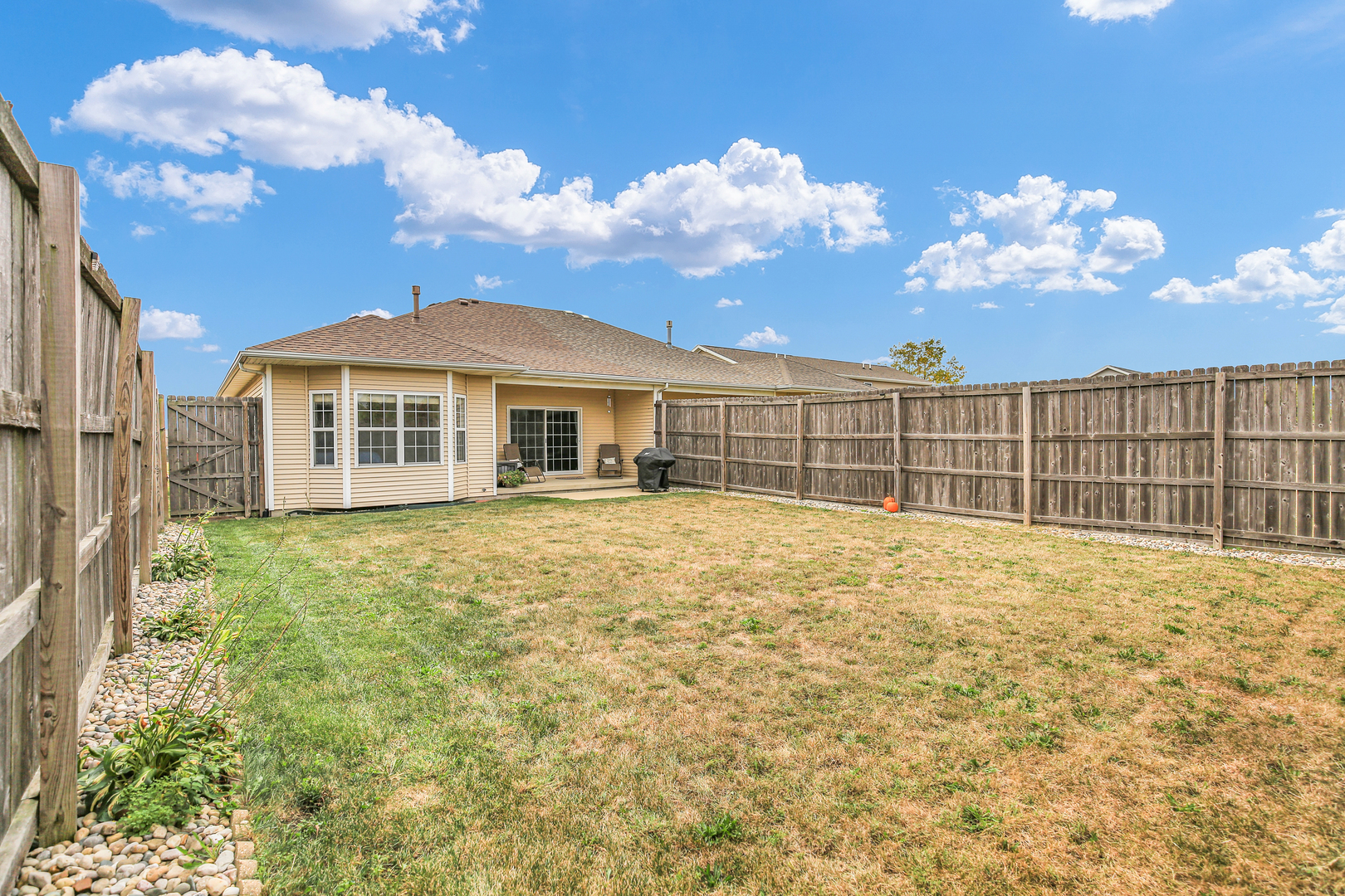 1504 Stonebluff Court, Unit 1504 Champaign, IL 61822 - Photo 35 of 40 a view of a house with a wooden fence