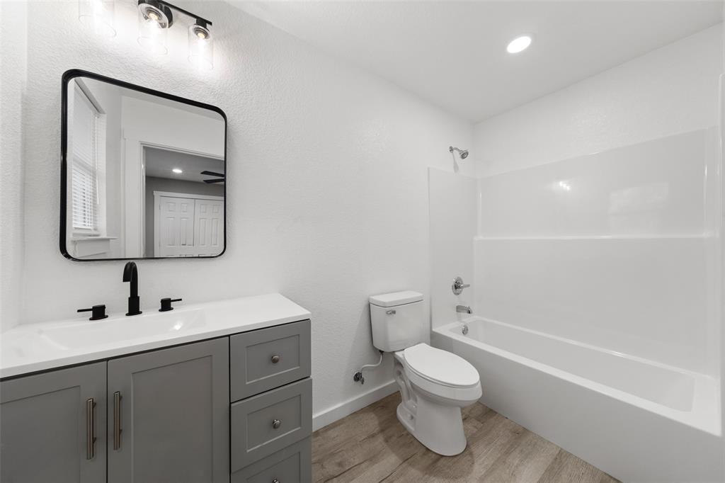 1905 Sanger Avenue Waco, TX 76707 - Photo 14 of 21 a bathroom with a toilet sink and mirror